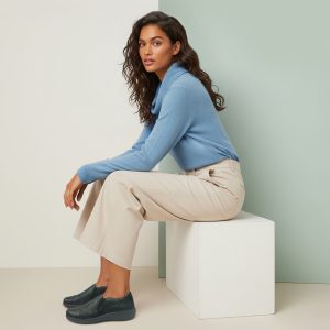 DM570W_lifestyle Aetrex Helena Slip On in Black on Lady Sitting Down