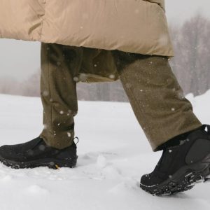Man Walking Through Snow Wearing Merrell Men's Coldpack 3 Moc in Black
