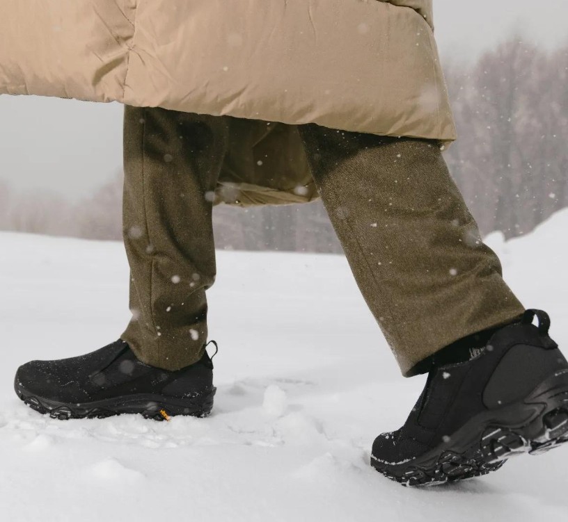Man Walking Through Snow Wearing Merrell Men's Coldpack 3 Moc in Black